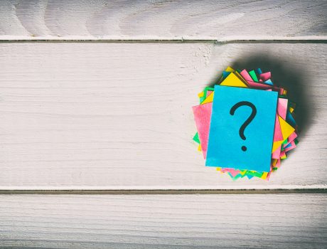 Just a lot of question marks on colored papers. vintage background