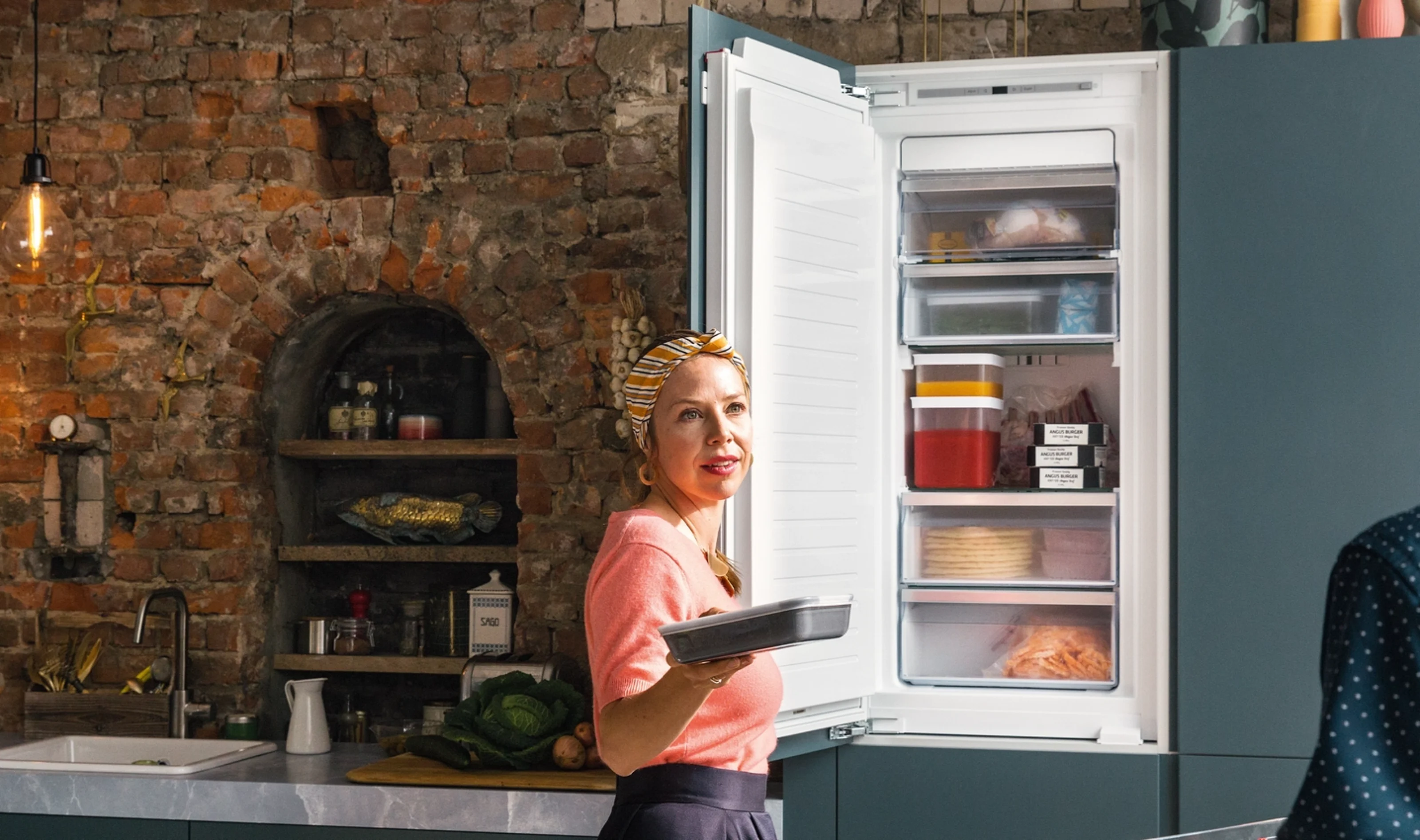 lady stood next to neff freezer
