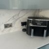 quartz worktop with metallic blue kitchen doors