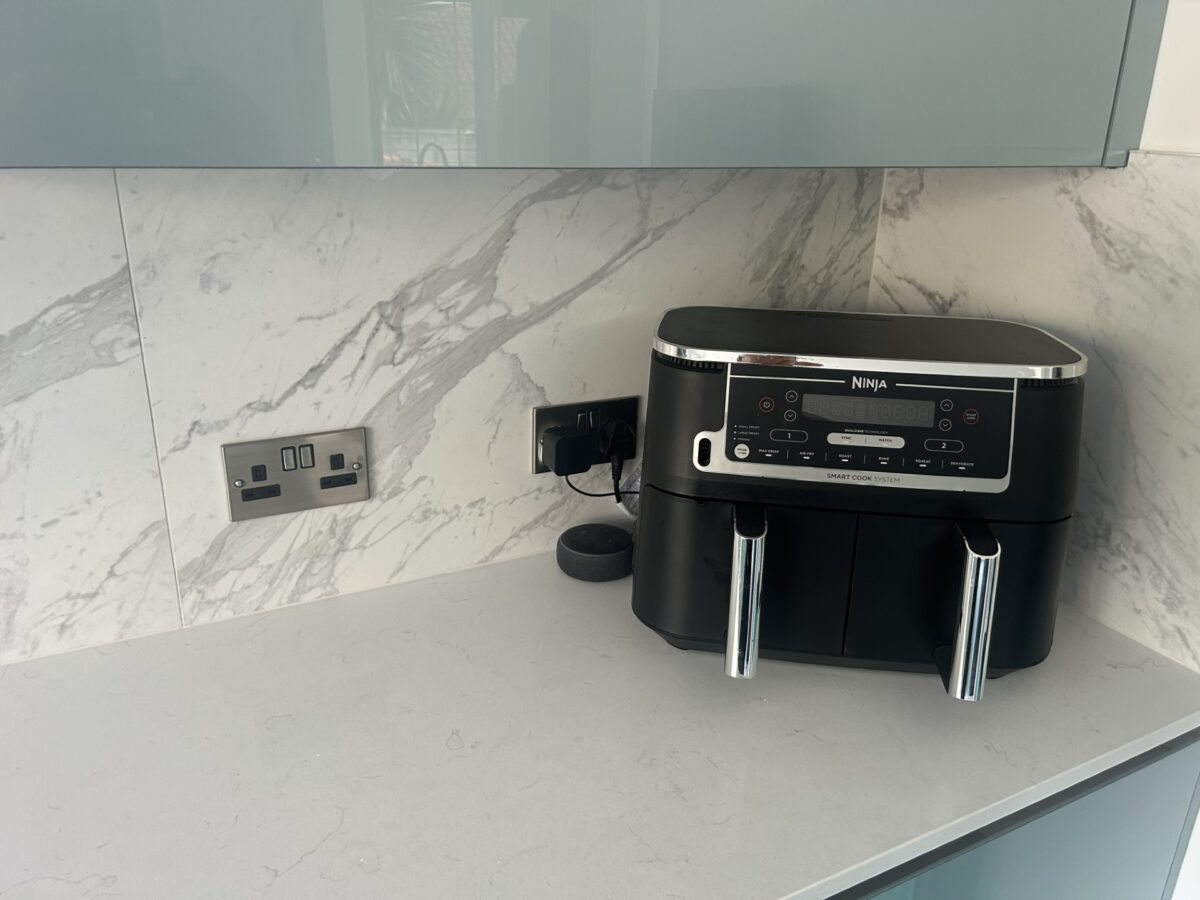 quartz worktop with metallic blue kitchen doors