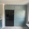 metallic blue kitchen cupboards with large american fridge freezer