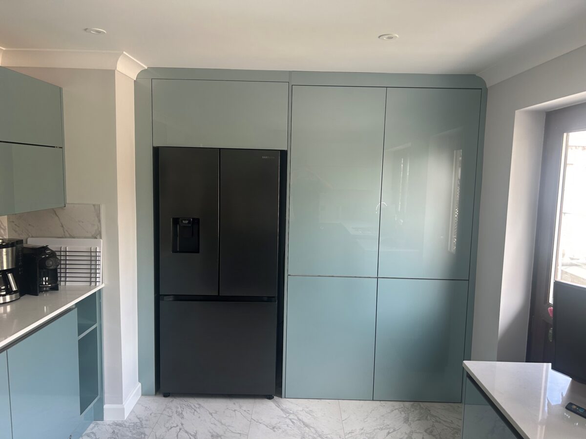 metallic blue kitchen cupboards with large american fridge freezer