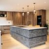 Metallic rock kitchen island with quartz worktop and neff induction hob