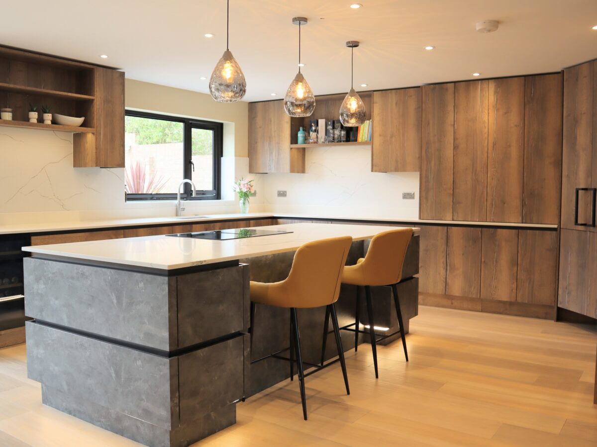 Metallic rock kitchen island with quartz worktop and neff induction hob